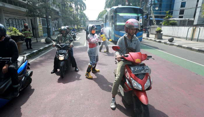 Cegah Penyebaran Virus Corona, Srikandi Damkar Kota Bandung Semprot Pengendara Motor